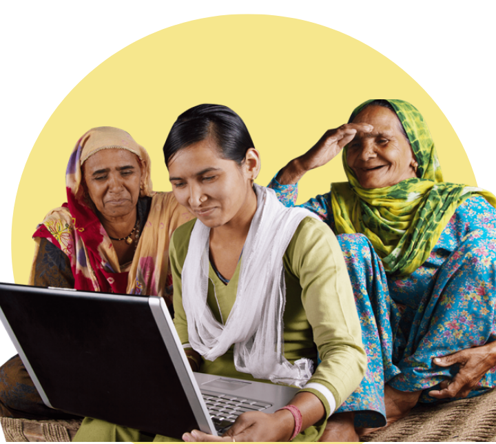 Three women looking at a laptop and smiling